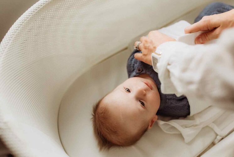 A baby boy in his SNOO bassinet rental getting ready for sleep.