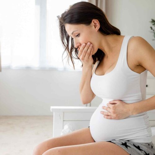 A woman with morning sickness using natural remedies for pregnancy nausea.