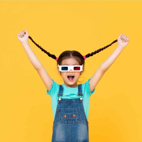 A little girl happily showing her hair braids to announce a mom hair hack.