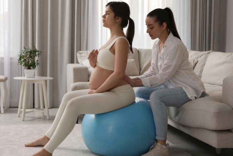 A pregnant woman on a birthing ball using her birth affirmations for an unmedicated labor.