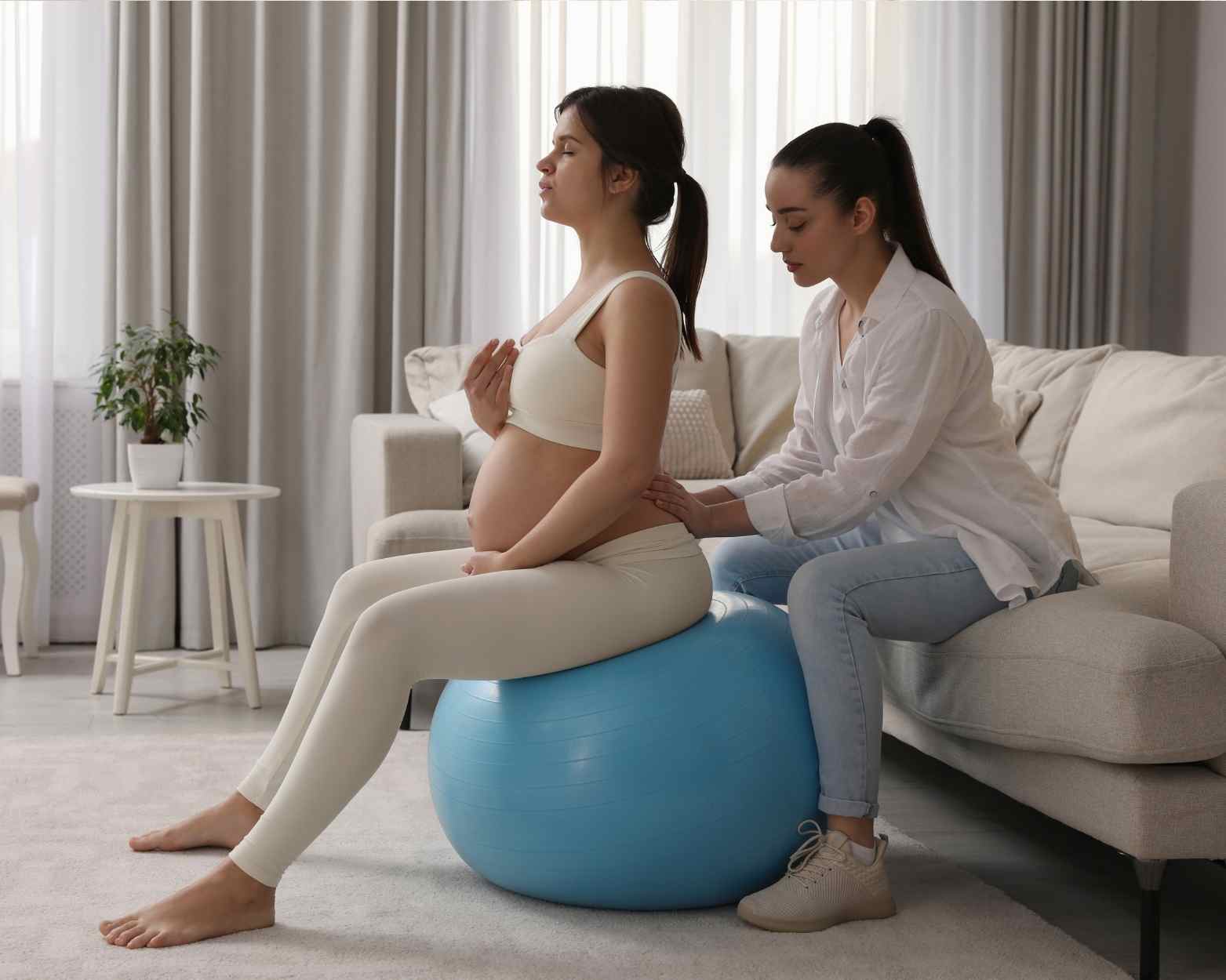 A pregnant woman on a birthing ball using her birth affirmations for an unmedicated labor.