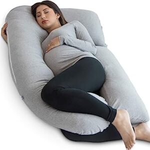 A pregnant woman sleeping in her pharmedoc pregnancy pillow.