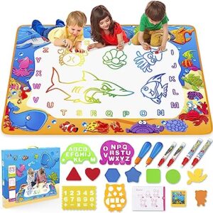 three toddlers drawing on their water doodle mat and smiling.